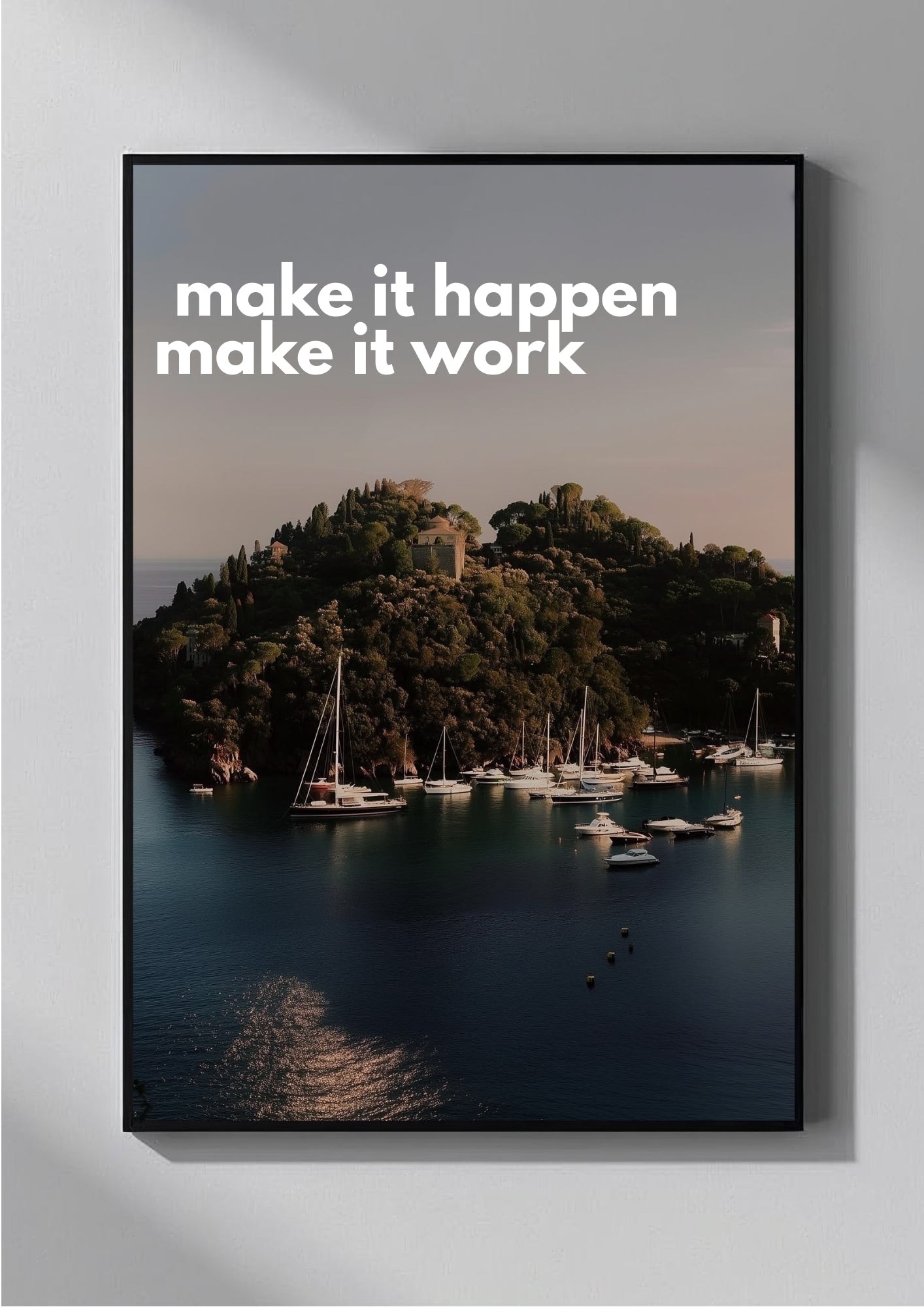 Framed poster with a scenic view of a harbor and 'make it happen make it work' text on a gray wall.